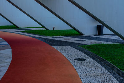 High angle view of railing by footpath in city