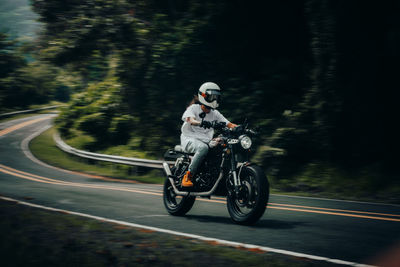 Man riding motorcycle on road