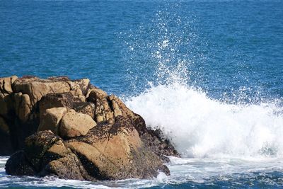 Sea waves splashing on rocks