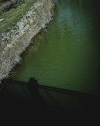 High angle view of silhouette railing by lake