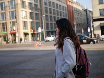 Side view of woman standing on city street