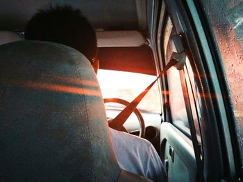 Rear view of man sitting in car