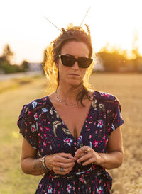 Young woman wearing sunglasses standing outdoors