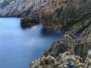 Scenic view of waterfall against sky