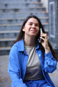 Woman is talking on the phone and laughing