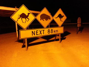 Close-up of arrow sign on road