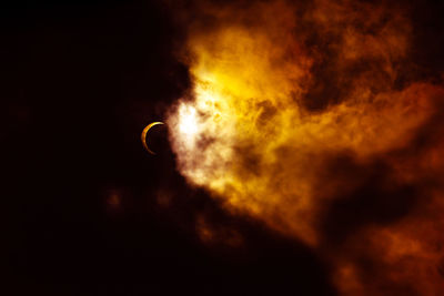 Low angle view of silhouette moon against sky at night