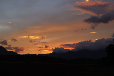 Scenic view of silhouette mountains against sky during sunset