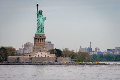 Statue of liberty with city in background