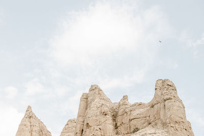 Low angle view of rock formation against sky