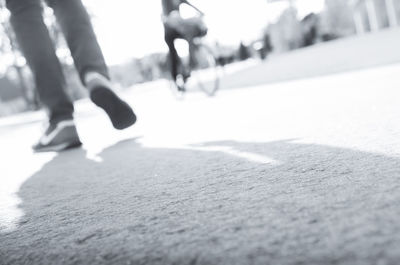 Low section of people walking on road