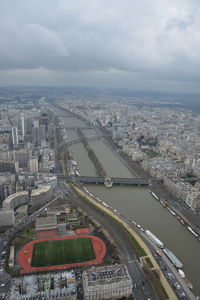 High angle view of paris against cloudy sky