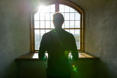 Rear view of man standing in building