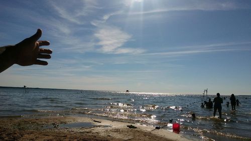 People on beach against sky