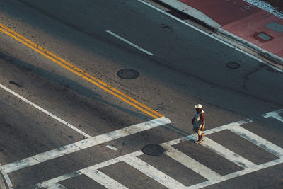 High angle view of man walking on a crossroad in miami