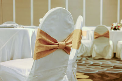 Close-up of chairs by table during wedding ceremony