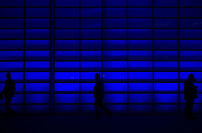 People walking in illuminated room