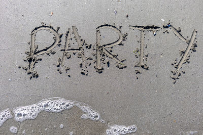 High angle view of footprints on sand