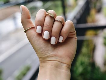 Close-up of person hand with manicure and jewelry 