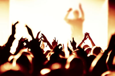 Close-up of hands of people at music concert