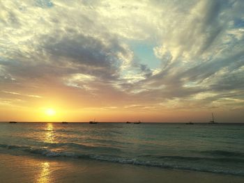 View of sea against cloudy sky during sunset