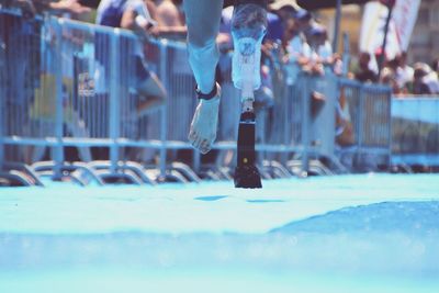 Low section of disabled athlete running on track