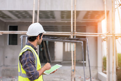 Side view of man working at construction site