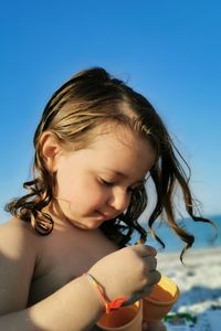 Cute girl looking away at beach