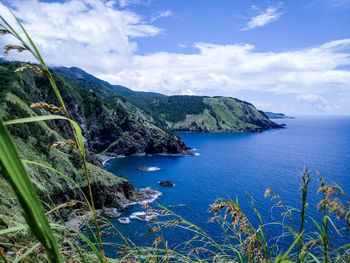 Scenic view of sea and mountains against sky