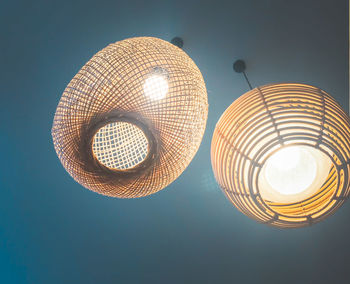 Low angle view of illuminated lamp against sky