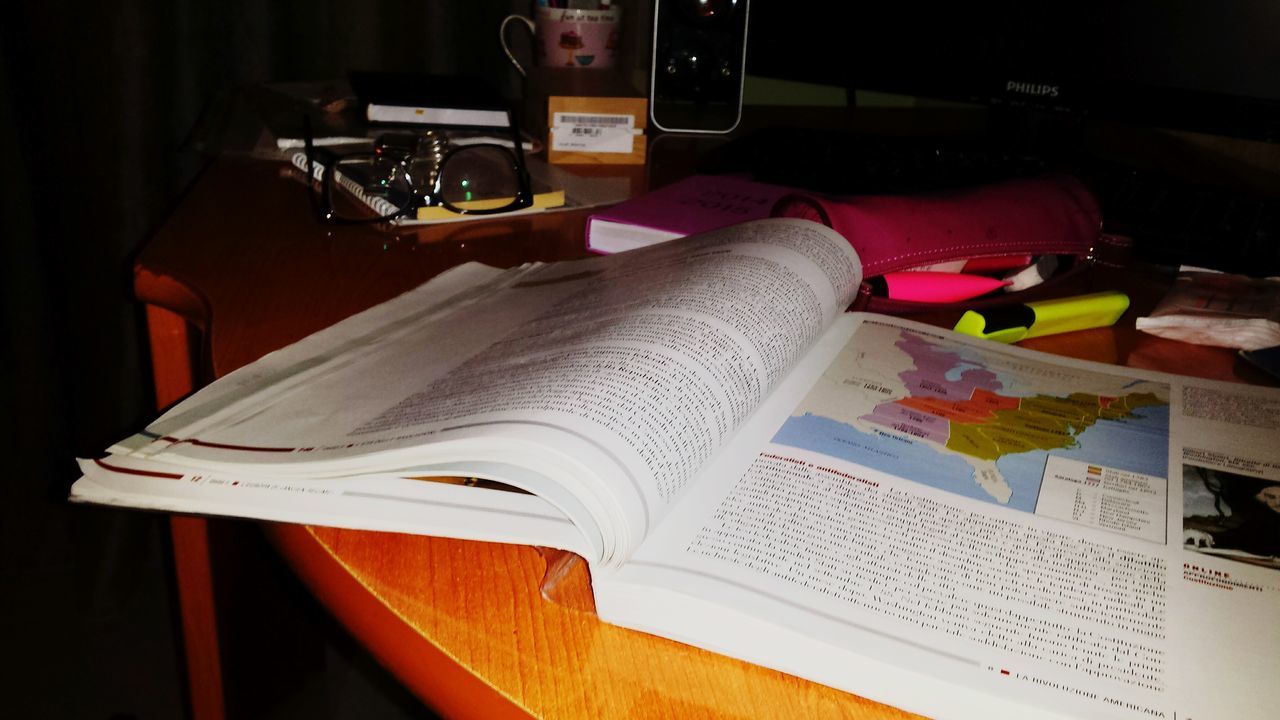 indoors, table, close-up, still life, book, high angle view, paper, technology, education, pen, home interior, no people, music, desk, wireless technology, communication, document, open, absence, wood - material