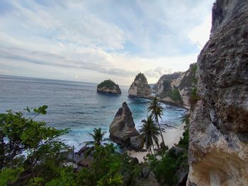 Rock formations in sea against sky