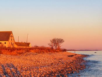 Scenic view of sea against clear sky during sunset