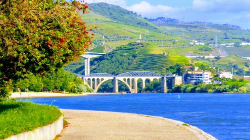 Scenic view of bridge over river against sky