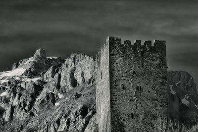 View of old ruins against cloudy sky