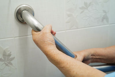 Close-up of man working on wall