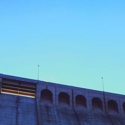 Low angle view of bridge against clear blue sky