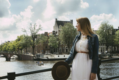 Woman overlooking canal city scape