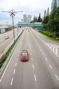 Cars on road in city against sky