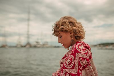 Portrait of woman looking at sea