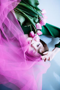 Portrait of woman with pink flower