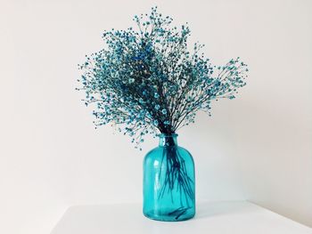 Close-up of blue vase against white background