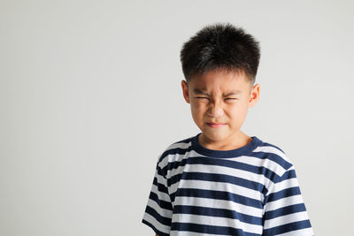 Young man standing against white background