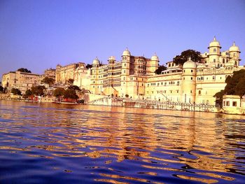 View of buildings against clear blue sky