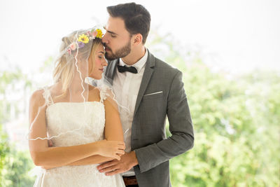 Young couple holding hands while standing outdoors