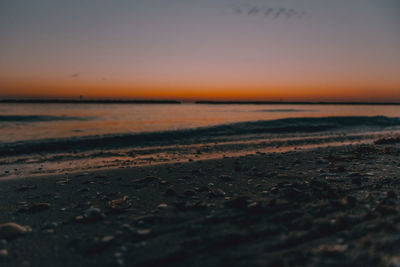 Scenic view of beach against sky during sunset