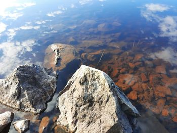 High angle view of rock formation in lake against sky