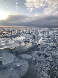 Scenic view of frozen lake against sky during winter