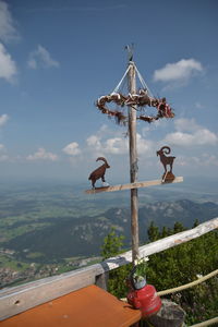 View of cross on mountain against cloudy sky