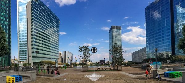 Modern buildings against cloudy sky